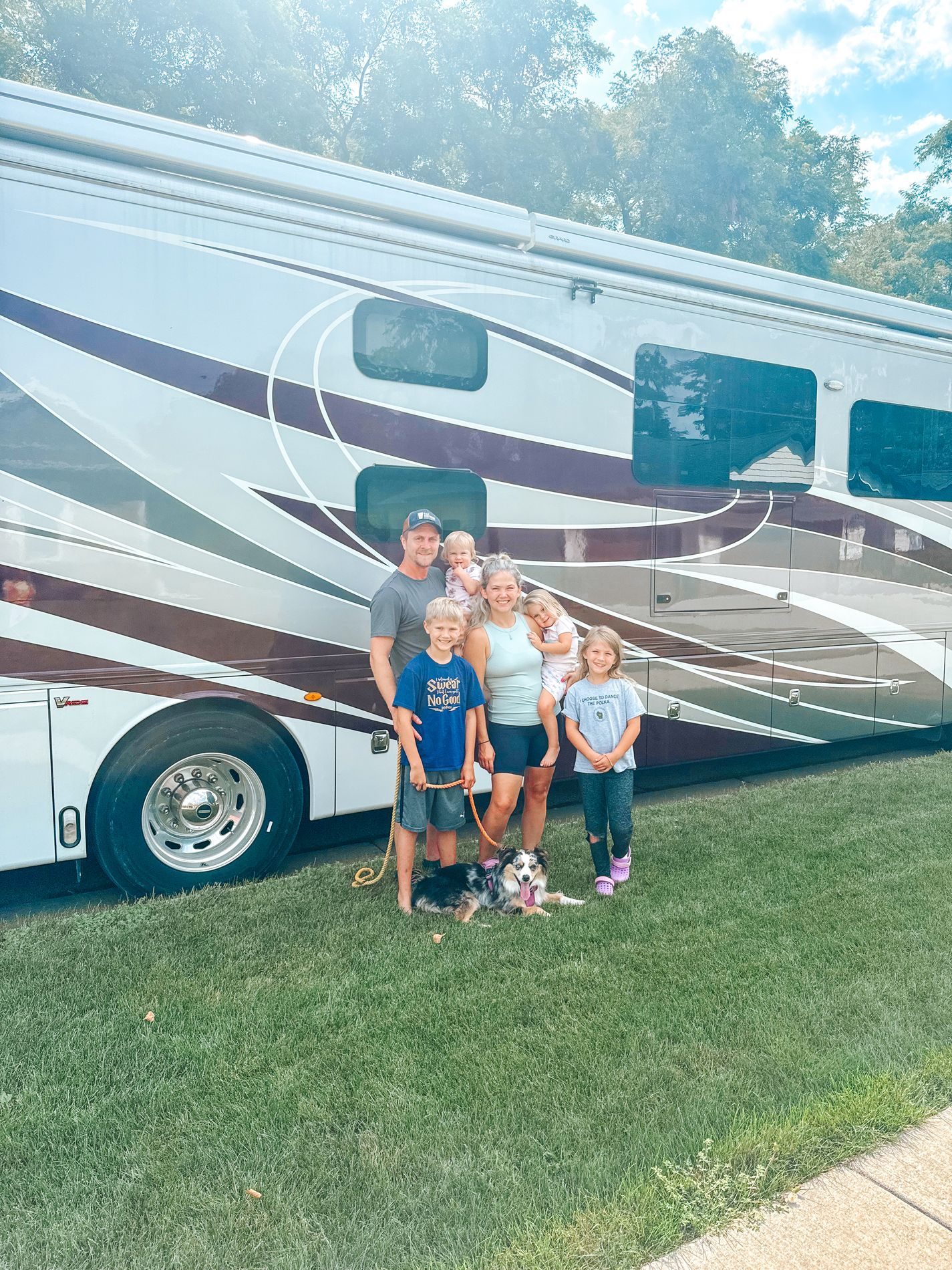 Our family and dog in front of the motorhome