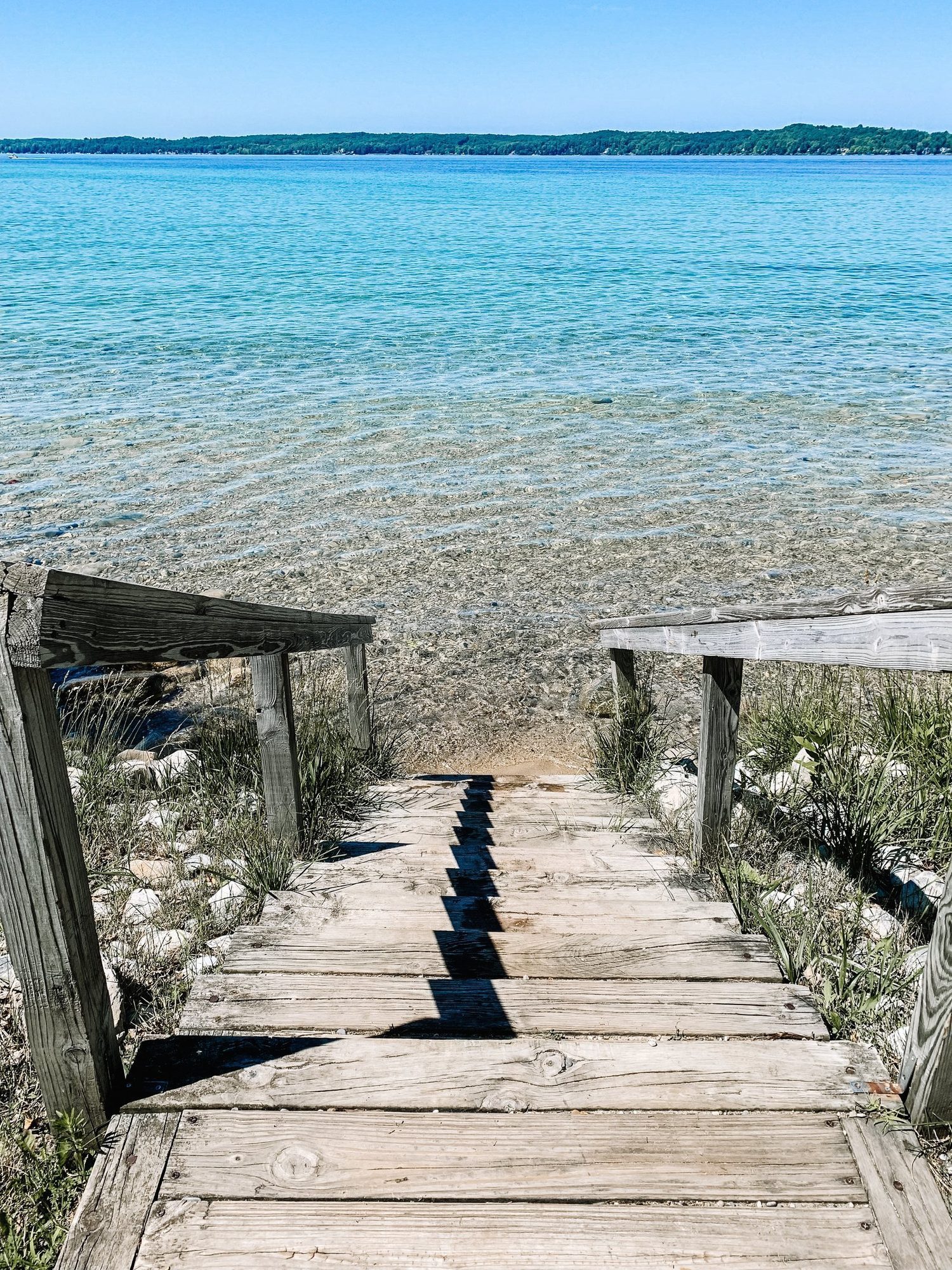 Wooden steps to a turquoise lake