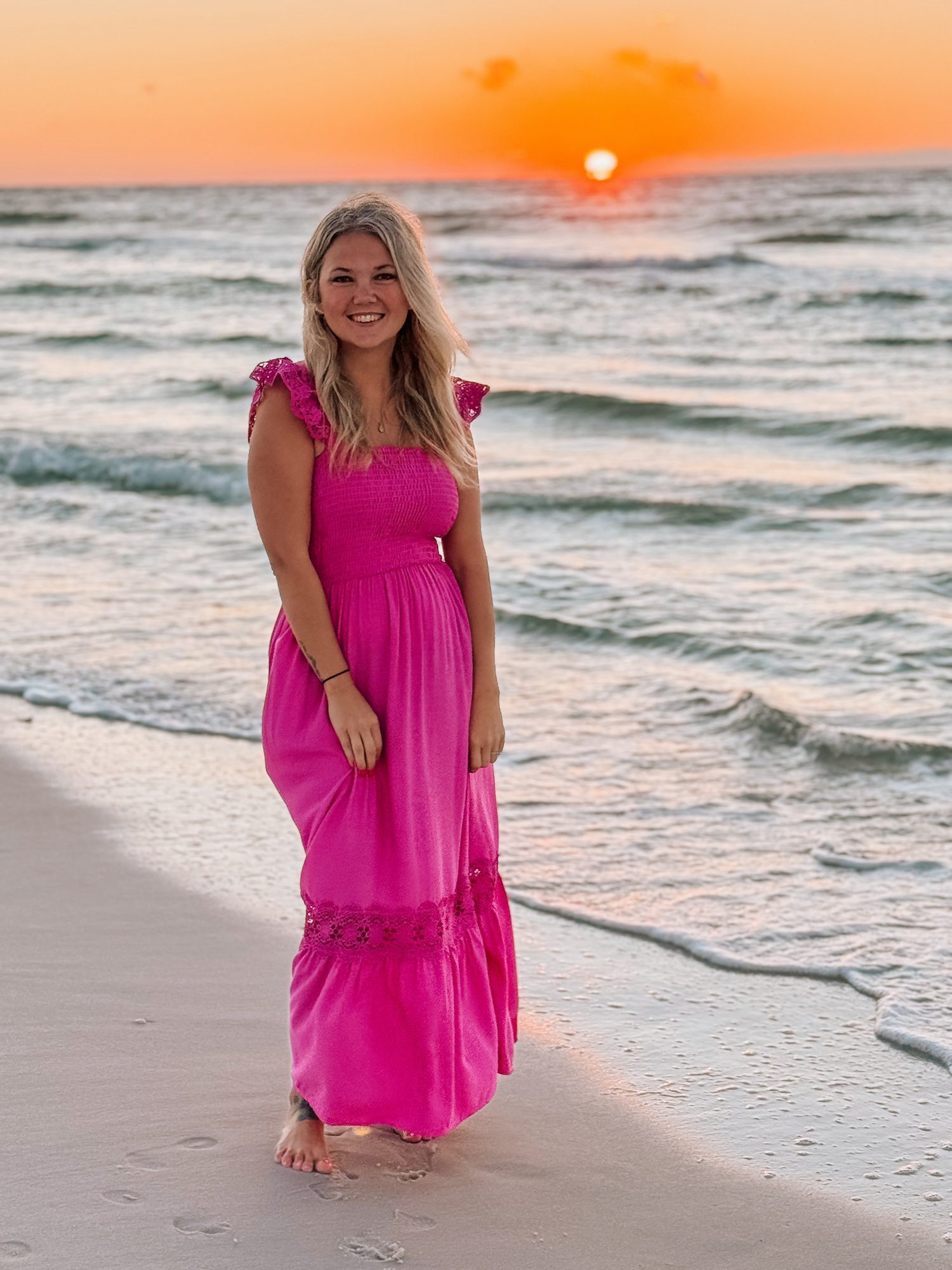 Samantha at sunset on the beach in a pink dress