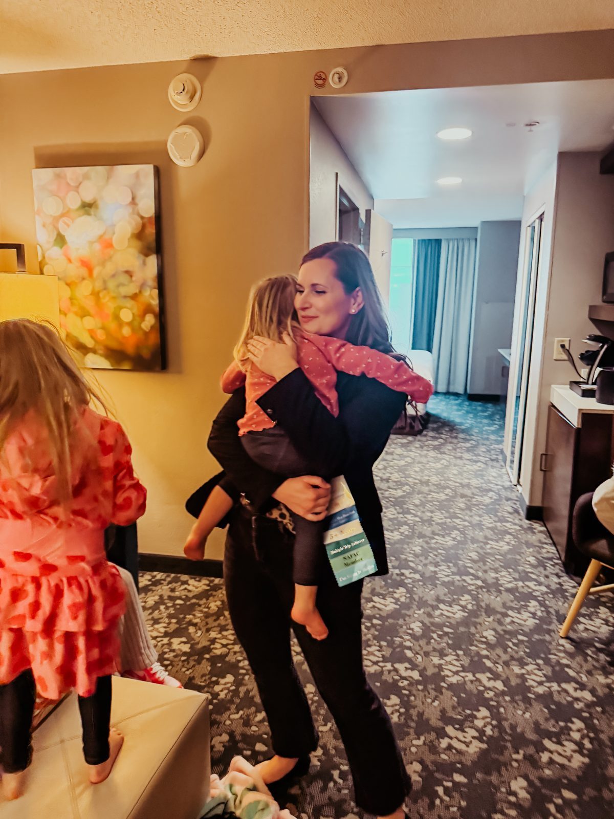 Emily holding Samantha's youngest in the hotel room
