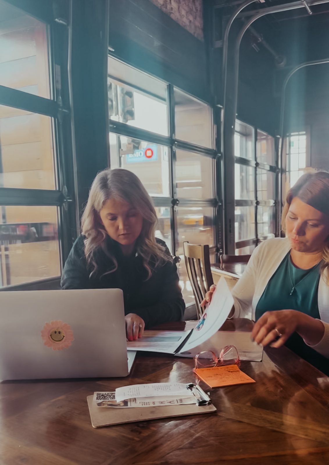 Samantha and Jennifer Piala working through workbook pages