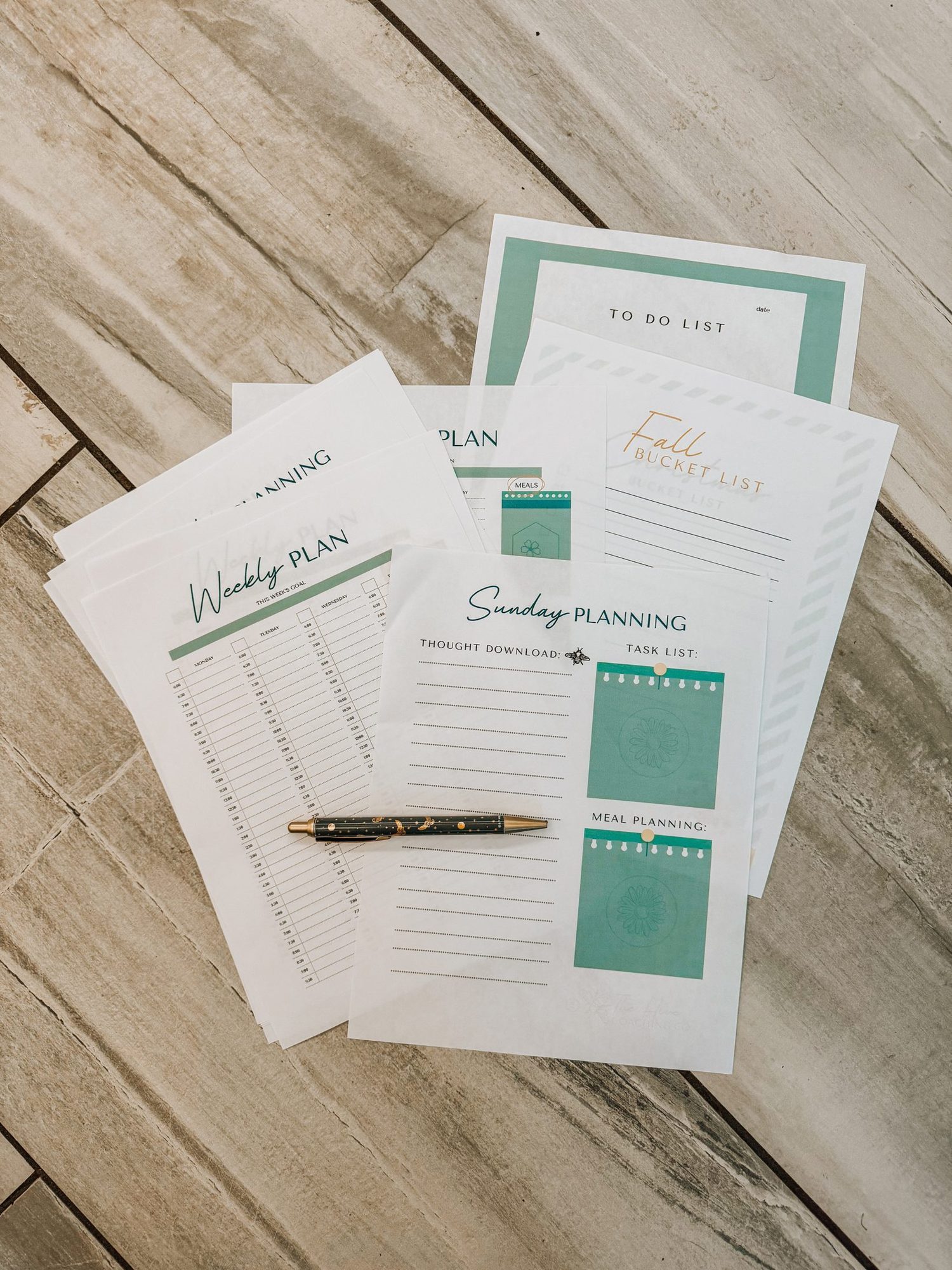 A flat lay of custom planning worksheets designed for The Hive Coaching Co.