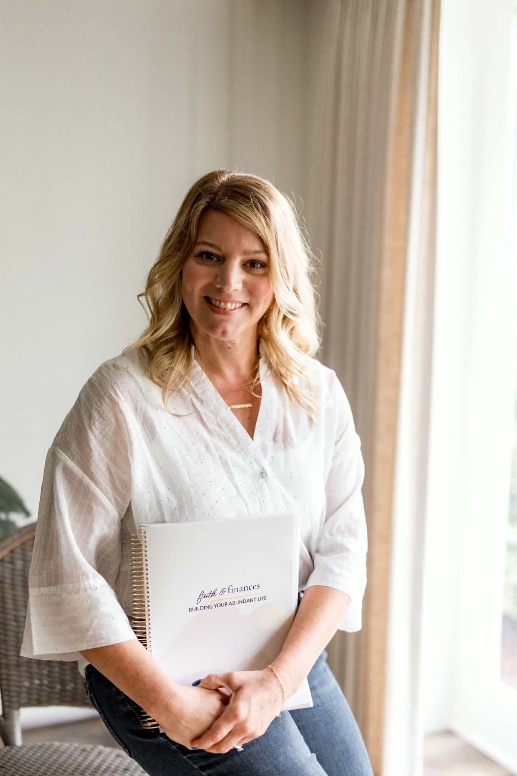 Jennifer Piala holding the Faith and Finances workbook