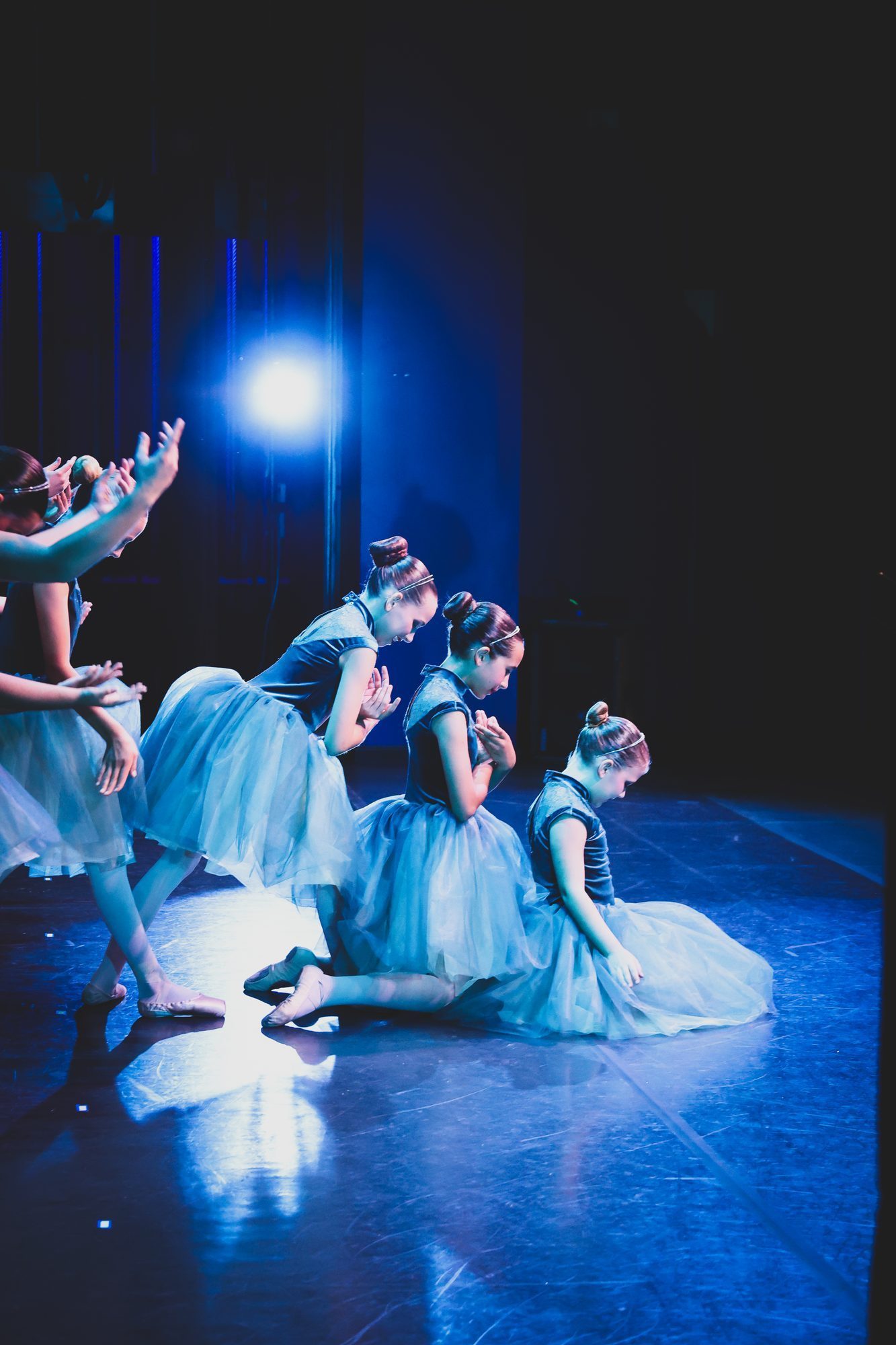 Sanctuary dancer on stage under warm recital lighting