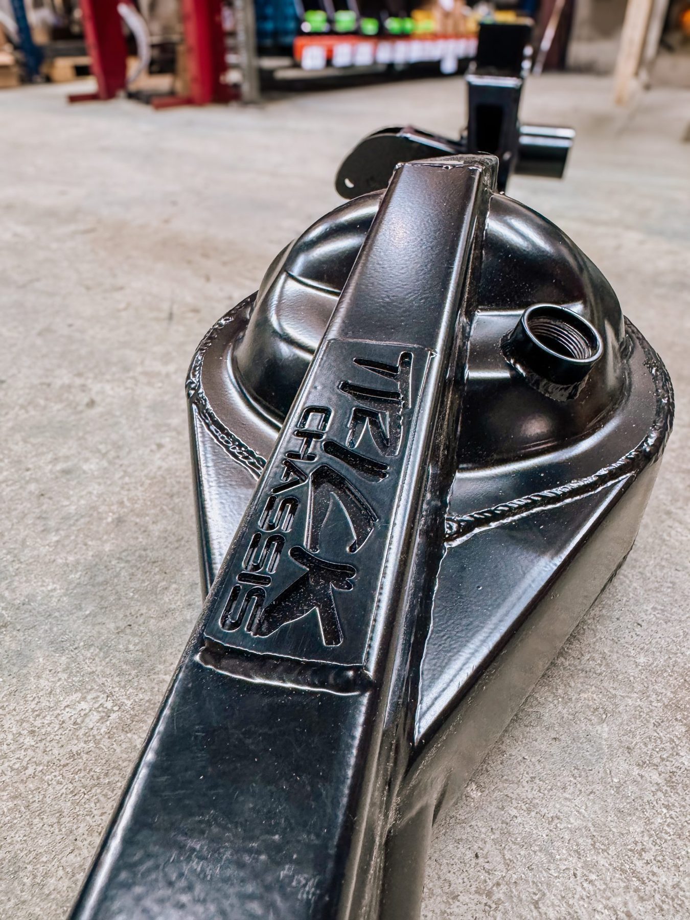 A Trick Chassis fabricated part with the logo embossed into the steel