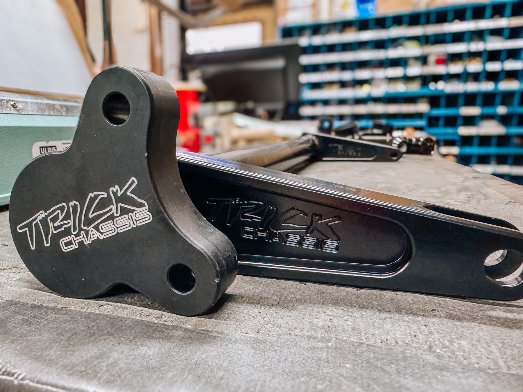 A pair of Trick Chassis fabricated parts with the logo machined into the steel