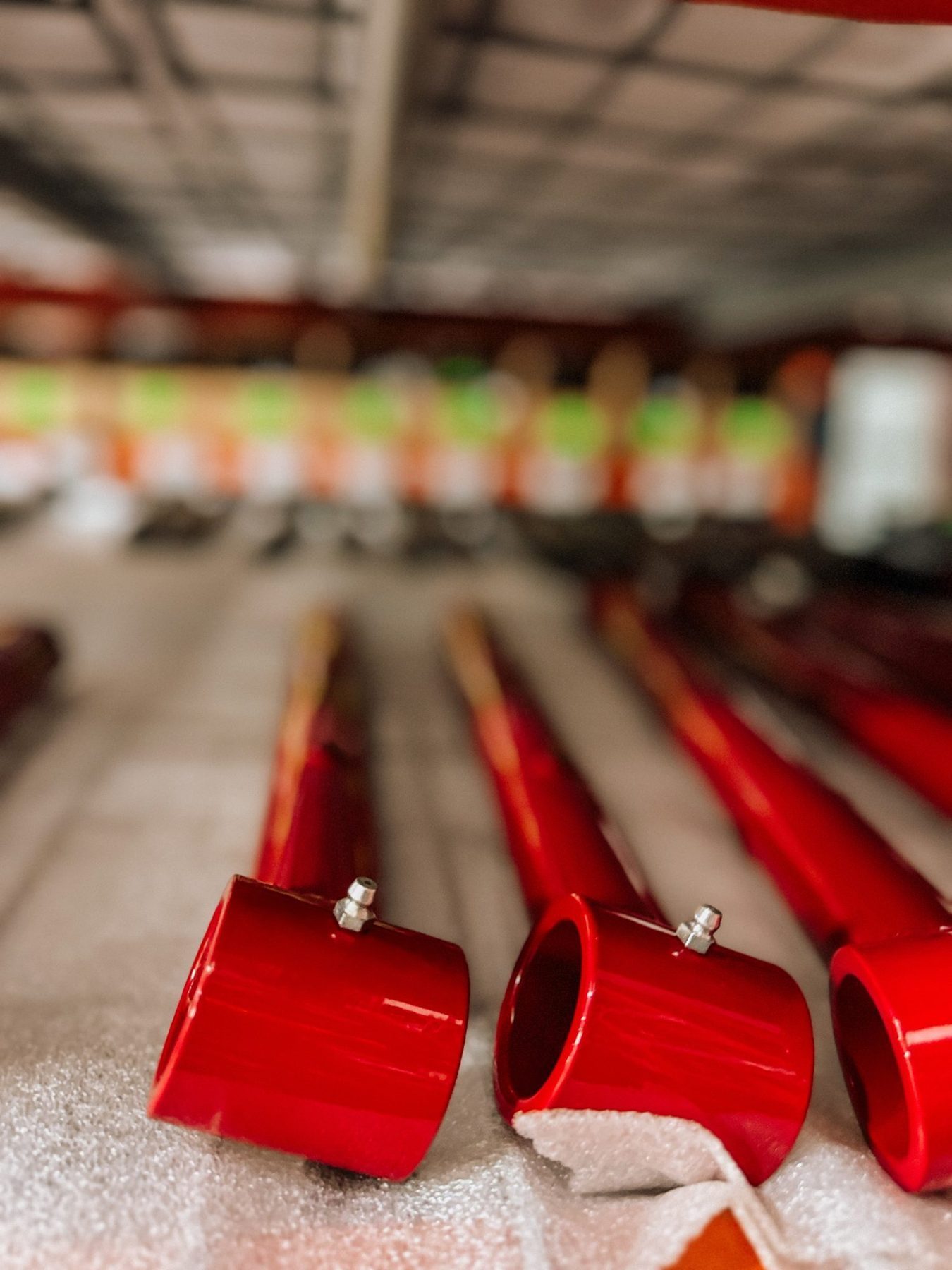 Trick Chassis red-coated tubes lined up in the shop