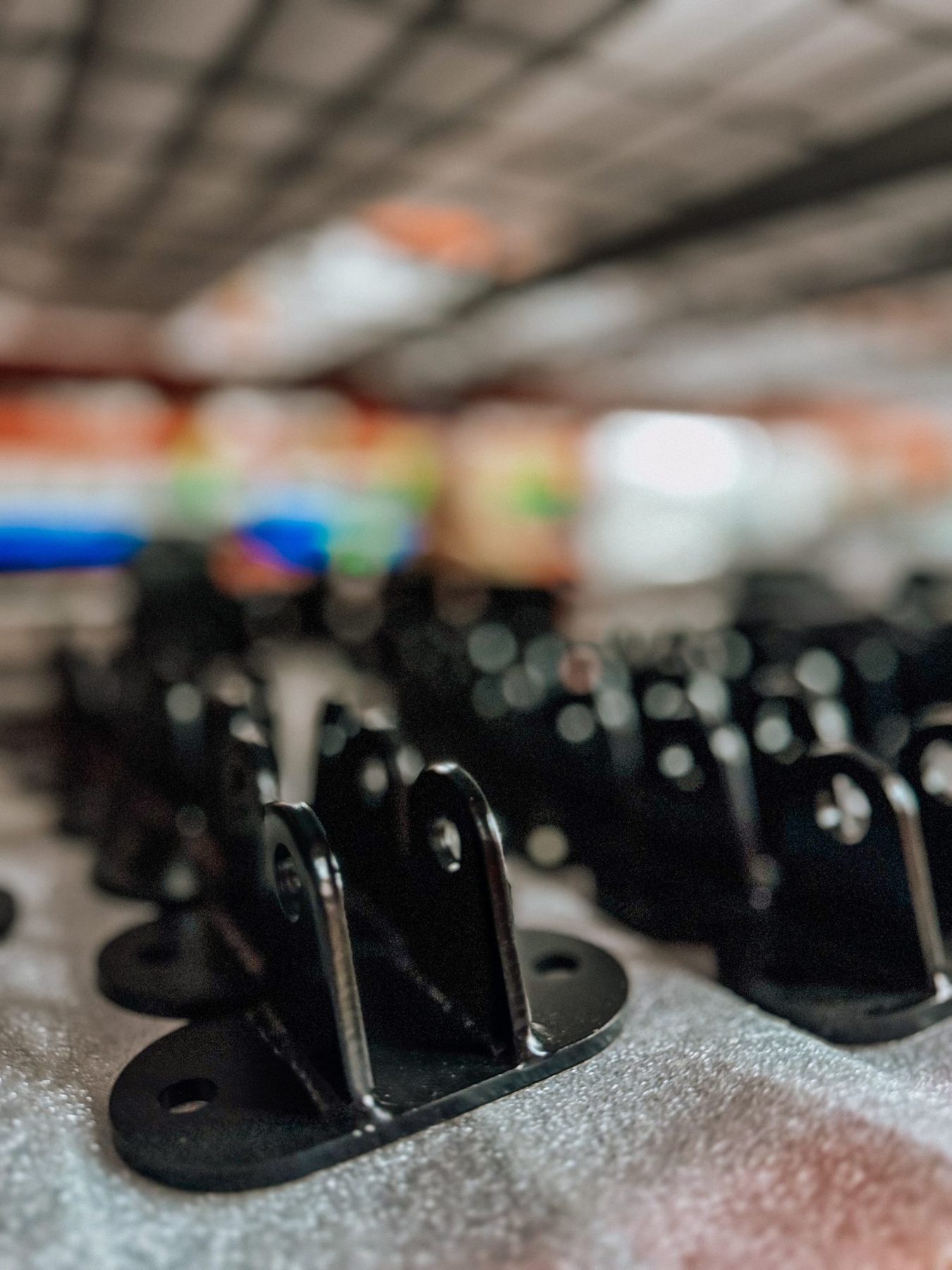 Rows of black Trick Chassis brackets ready to ship
